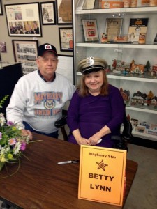 DON’T WEAR MY HAT, THEL!–Ted Womack with Betty Lynn, who’s wearing his Mayberry Deputy hat during her autograph session at the Andy Griffith Museum in January. (Well, O.K., you can wear my hat, but just this once.)