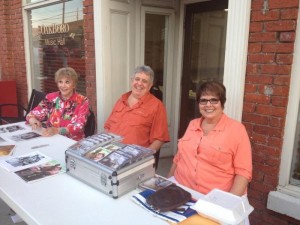 Maggie Peterson (left) with Rodney Dillard and his wife, Beverly, offer their musical wares at the Oakboro Cruise-In on Aug. 22, before heading over to Troy for the next night's DARE fundraiser concert. Photo by Tom Rusk.