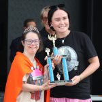 Mayberry Days World Championship of TAGS Trivia Champion Lillie Lobb is presented her trophy by Miss Mayberry Sarah Blaine. Lillie is the youngest adult champion in the 36 years of Mayberry Days.