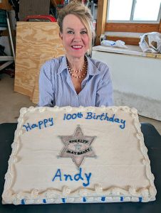 Macon, Mo. - Dixie cut her dad's cake for the Blood Brothers chapter members after all members acknowledged Andy's centennial birthday and the relevance of TAGS to today's society.